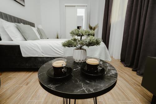a coffee table with two cups of coffee on it at M & N Guesthouse in Volos