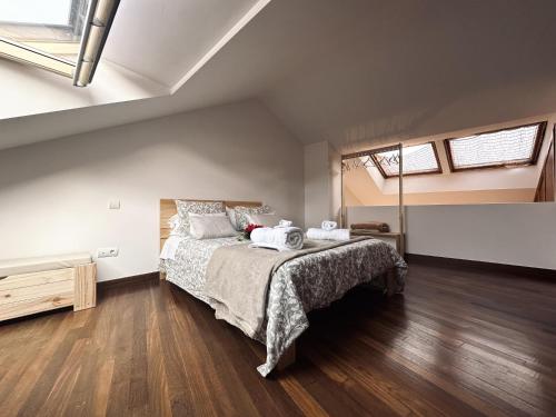 a bedroom with a large bed and wooden floors at La Casa Vieja - 12010 in Ajo