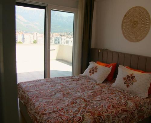 a bedroom with a bed with a view of a balcony at The Olive Trees Penthouse - two bedroom in Bar