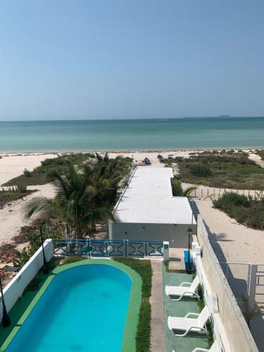 a view of the beach from the balcony of a resort at Playa Arena in Progreso