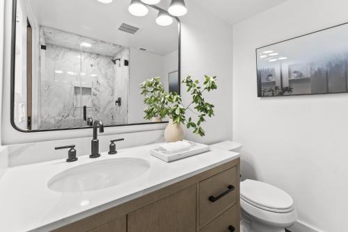 a bathroom with a sink and a toilet and a mirror at Canyons Creekside 3b3ba Townhouse 1 Block to Ski Lift in Park City