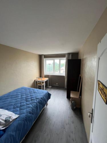 um quarto com uma cama, uma secretária e uma janela em Appartement Familial avec Vue sur La Tour Eiffel em Clichy