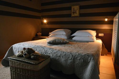 a bedroom with a bed with a teddy bear sitting on it at MARGOT'L in Rochefort