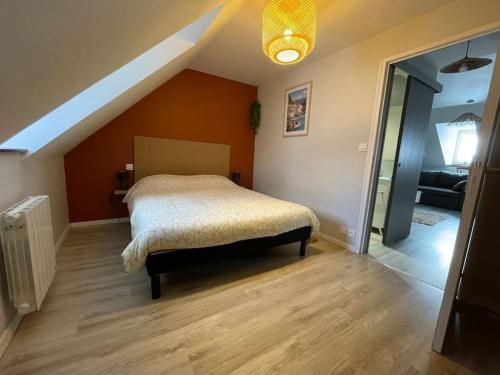 ein Schlafzimmer mit einem Bett im Dachgeschoss in der Unterkunft T2 cœur de ville thème bohème in Rodez