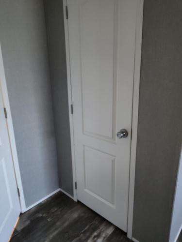 eine weiße Tür in einem Zimmer mit Holzboden in der Unterkunft Riley's Pad Master Suite in Sevierville
