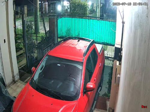 a red car parked in front of a house at Buenos Aires Tango Apartment near Golf in San Antonio de Padua