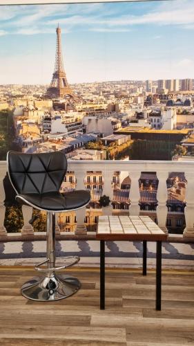 a chair sitting on a table in front of the eiffel tower at Bungalow Alex in Dresden