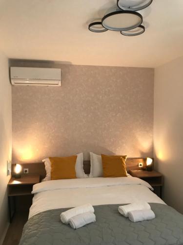 a bedroom with a bed with two pillows on it at Race for Space in Niš