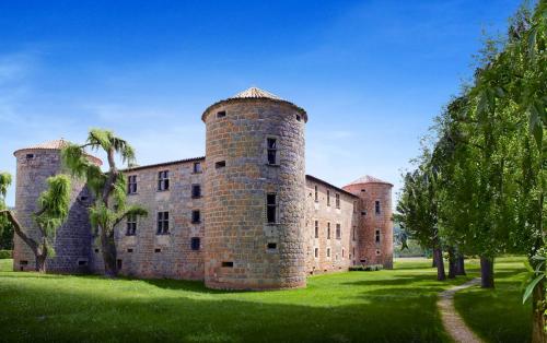 a large brick building with palm trees in front of it at Maison de 2 chambres avec vue sur la ville a Chalabre a 4 km de la plage in Chalabre