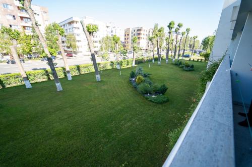 a view of a yard with trees and grass at Hotel Apollo in Mamaia