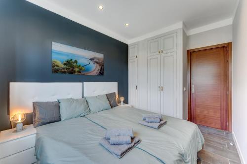 a bedroom with a large bed with two towels on it at Sea View Apartment Magic Moments Adeje in Adeje