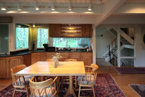 a kitchen with a wooden table and chairs at Elegant Lodge with Hot Tub Walk to Highland Lifts in Aspen