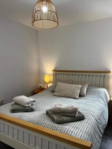 a bedroom with a bed with two pillows on it at The Salt Locker in Porthleven