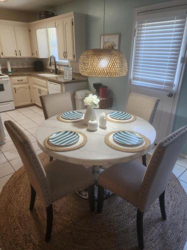 a kitchen with a table with chairs and a dining room at PEBBLES' BEACH HOUSE in Edinburg