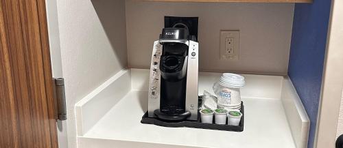 a hair dryer sitting on a shelf in a room at Holiday Inn Express Hotel and Suites Mesquite by IHG in Mesquite