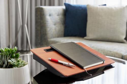 a table with a laptop and a pen on it at Crystal Gateway Marriott in Arlington