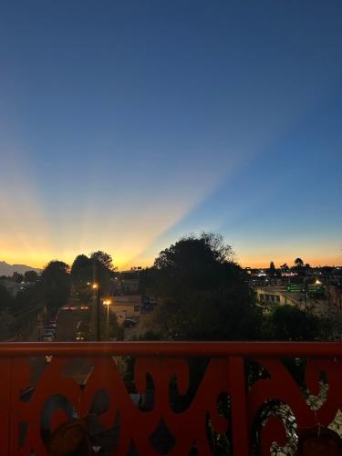a view of a sunset from a balcony at Hostal Talavera in Puebla