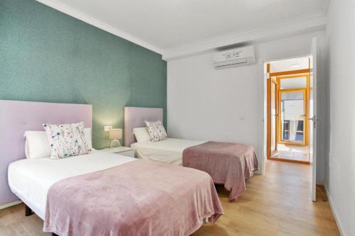 מיטה או מיטות בחדר ב-Villa Mariposas Caleta