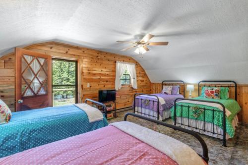 a bedroom with two beds and a ceiling fan at River Gem in Creede