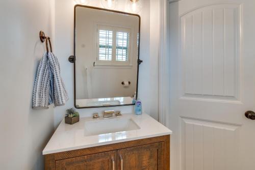 a bathroom with a sink and a mirror at Prime Peoria Retreat with Deck and Fireplace! in Peoria