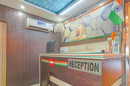 a reception desk in a hotel room with a sign at Flagship The Leggend Inn Hotel in Patna