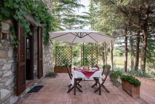 a table with an umbrella on a patio at Agriturismo Terre della Rinascita in Castelnuovo della Misericordia