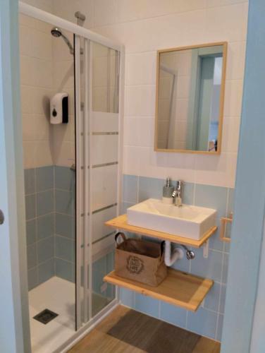 a bathroom with a sink and a shower at Maria Sardinha_As Três Marias in Matosinhos