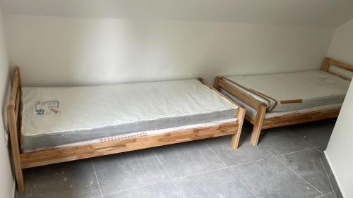 two beds sitting next to each other in a room at Bosnia GCC in Vinogradi