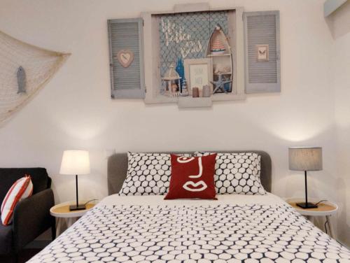 a bedroom with a bed with a red pillow on it at Maria do Mar_As Três Marias in Matosinhos