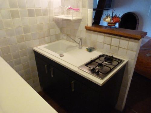 a kitchen with a sink and a stove at Villa A Pineta in Porticcio