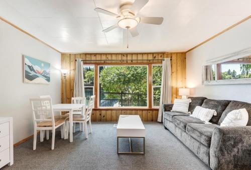 a living room with a couch and a table at Bend Riverside Condos Near Downtown Bend in Bend