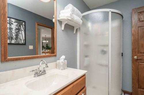 a bathroom with a sink and a shower at Grand Palace in Sioux Falls