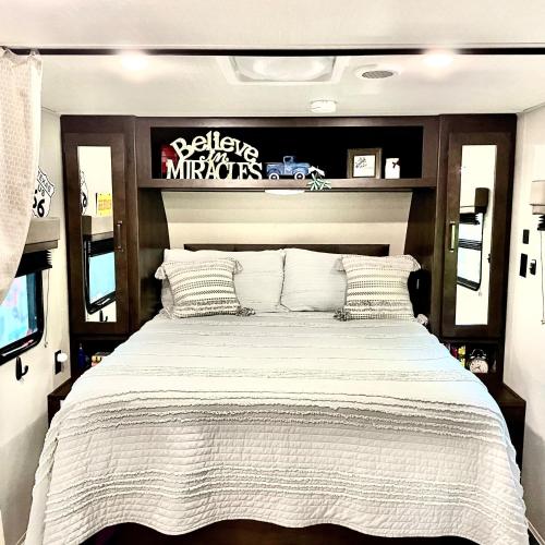 a bedroom with a large bed in a rv at Pet Friendly Graham Home Route 66 at The Mistletoe Farm in Graham