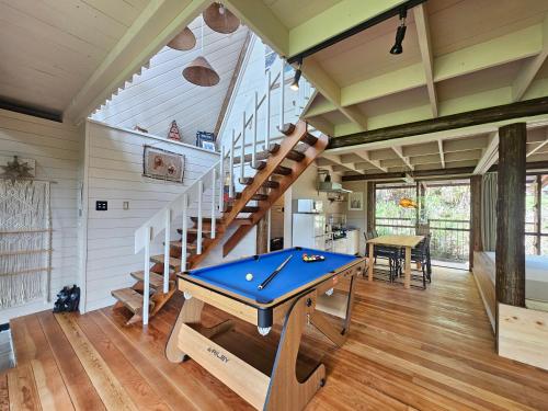 a room with a ping pong table and stairs at LOGIN OKlNAWA -native- in Inbu