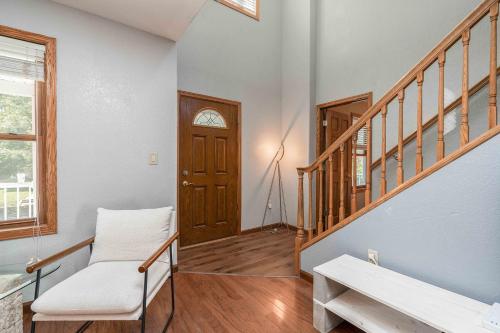 a living room with a staircase and a wooden door at Grand Palace in Sioux Falls