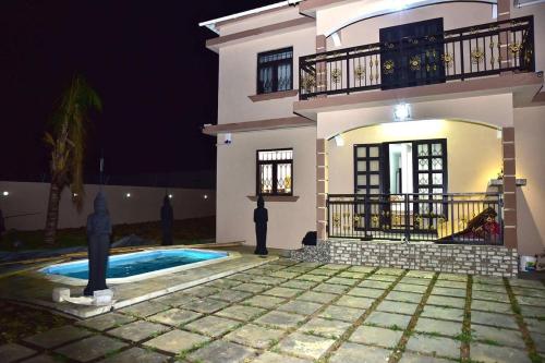 a house with a swimming pool in front of it at Villa Royal Bhudha in Goodlands