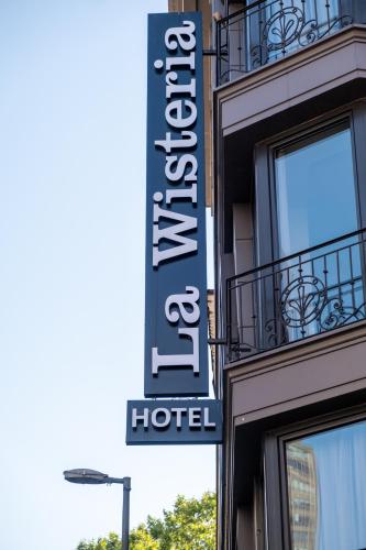 a hotel sign on the side of a building at La Wisteria Boutique Hotel Istanbul in Istanbul