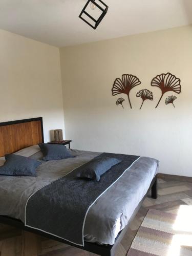 a bedroom with a bed with three palm trees on the wall at Cabana Villa Alpina in Villa Alpina