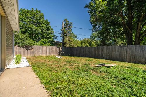 a backyard with a fence and a bench in the grass at Grand Palace in Sioux Falls