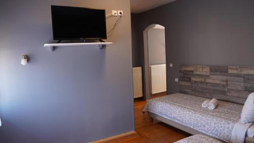 a bedroom with a bed and a flat screen tv at Casablanca in Niš