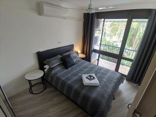 a bedroom with a bed with a tray on it at Residential two bedroom, self-contained, renovated apartment, Sheridan St, self check-in in Cairns