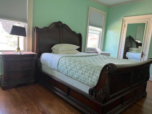 a bedroom with a large bed with a dresser and a mirror at Boston shot stay 1 in Everett