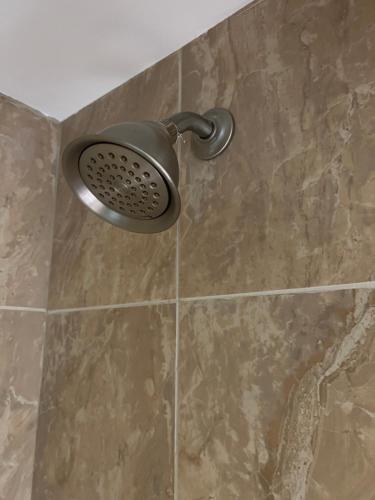 a shower with a shower head in a bathroom at Boston shot stay 1 in Everett