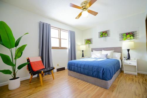 a bedroom with a bed and a ceiling fan at Blue House 2 in Sioux Falls