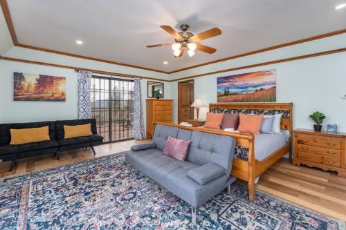 a living room with a couch and a bed at Sunset Retreat- TWO houses with hot tub, firepit, multiple kitchens, sleeps 20 in Coarsegold