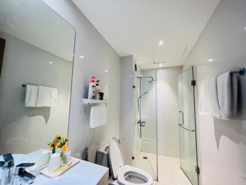 a bathroom with a shower and a toilet and a sink at Blue Rose - Sea View, High Floor, 70m2 apartment, 2 Bedrooms, 2 WC, in Ha Long
