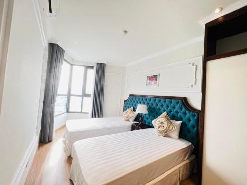 a hotel room with two beds and a window at Blue Rose - Sea View, High Floor, 70m2 apartment, 2 Bedrooms, 2 WC, in Ha Long