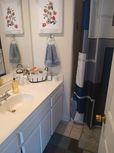 a bathroom with a sink and a mirror at Levander Cozy Home in Alhambra