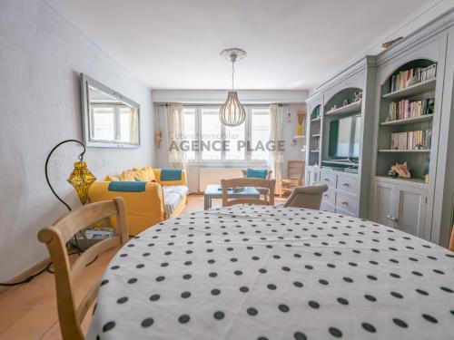 a dining room with a table and a living room at Maison 3 chambres, accès plage direct, proche centre et commerces - FR-1-197-550 in Les Sables-dʼOlonne