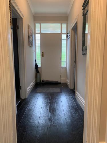 an empty hallway with a door leading to a room at Roslyn Business Studio - 2 bedroom in Dunedin